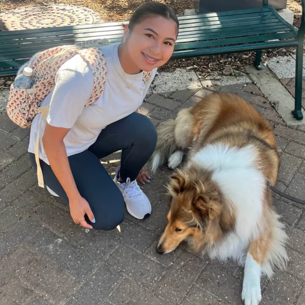 Young woman with a Collie dog at Lucky Paws BCS, LLC.